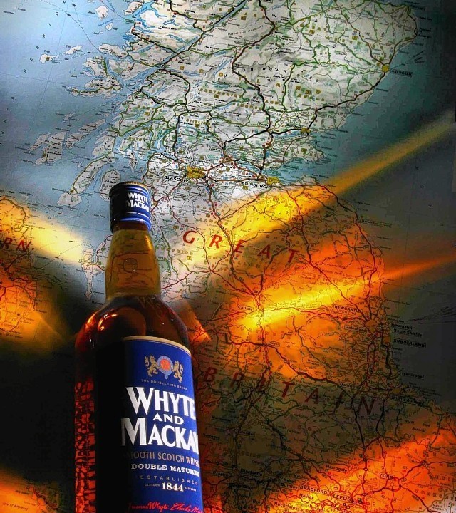 Whyte & Mackay bottle against sunset.